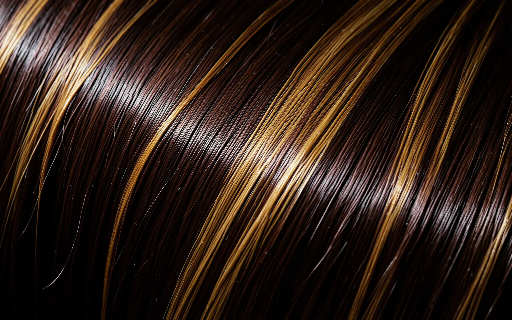 A glossy sheet of espresso hair woven with honey blonde highlights (illustrative, generated).
